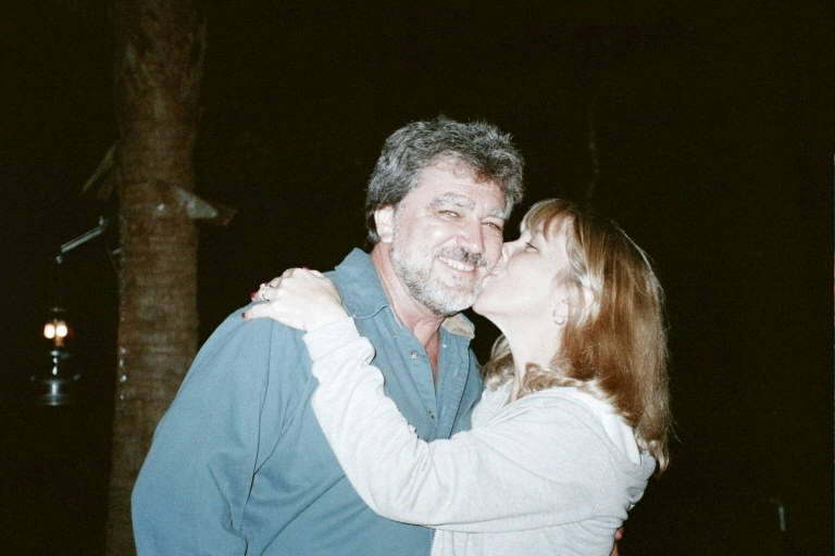 Susie plants a birthday kiss on Steve who just turned one year older than dirt